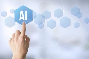 Sormi koskettaa kuusikulmaista symbolia missä lukee AI